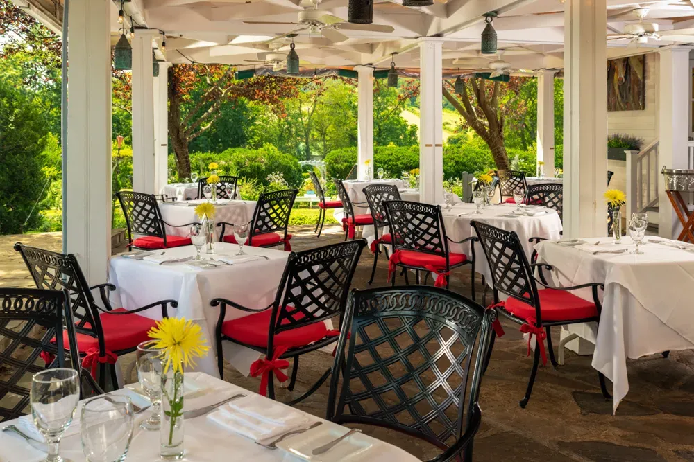 Patio dining area surrounded by fall foliage